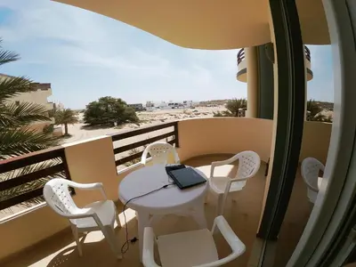 a balcony with a table and chairs with a laptop on it at Endless Summer B6 in Sal Rei