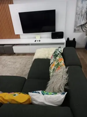 a living room with a couch and a tv at Apartamento de Luxo -T2 in Praia