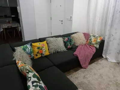 a black couch with colorful pillows on it in a living room at Apartamento de Luxo -T2 in Praia