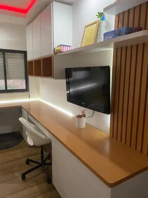 an office with a desk with a television on it at Apartamento de Luxo -T2 in Praia