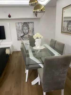 a dining room with a glass table and chairs at Apartamento de Luxo -T2 in Praia