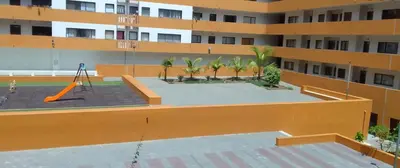 an apartment building with a playground in the courtyard at Apartamento de Luxo -T2 in Praia