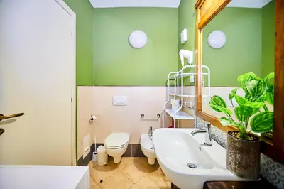 a bathroom with a sink and a toilet and a mirror at Tropical Casa Verde Santa Maria G01 in Santa Maria
