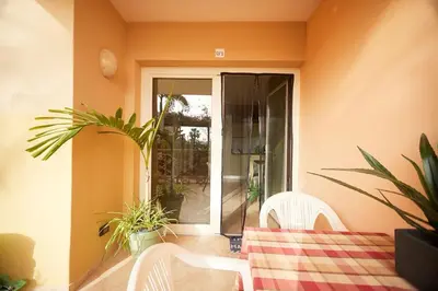a patio with a table and chairs and plants at Tropical Casa Verde Santa Maria G01 in Santa Maria