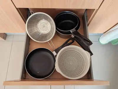 four pots and pans sitting on a shelf in a kitchen at SeafrontView - Cozy T1 Apartment 2 in Praia