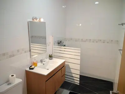 a bathroom with a sink and a mirror and a toilet at SeafrontView - Cozy T1 Apartment 2 in Praia