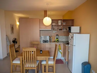 a kitchen with a table and a white refrigerator at SeafrontView - Cozy T1 Apartment 2 in Praia