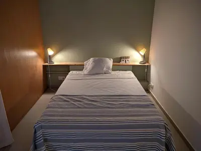 a small bed in a small room with two lamps at SeafrontView - Cozy T1 Apartment 3 in Praia