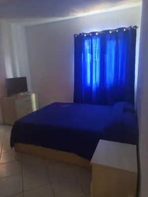a bedroom with a blue bed and a blue curtain at Appartamento Teresa in Santa Maria