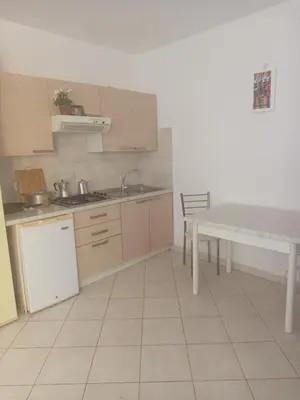 a kitchen with a table and a sink and a counter at Appartamento Teresa in Santa Maria