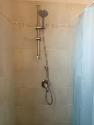 a shower with a shower head in a bathroom at Appartamento Teresa in Santa Maria