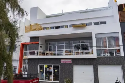 a large white building with a balcony at Laranjinha Rooms in Paul
