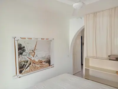 a bedroom with a picture of a woman on the wall at Canova Apartment in Santa Maria