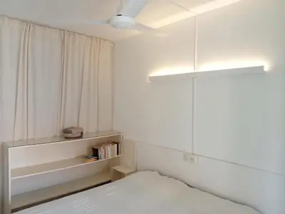 a small bedroom with a bed and a window at Canova Apartment in Santa Maria