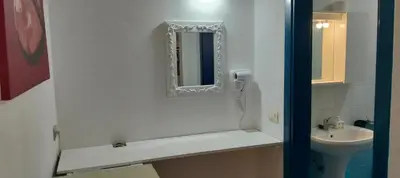 a bathroom with a sink and a mirror on the wall at Canova Apartment in Santa Maria