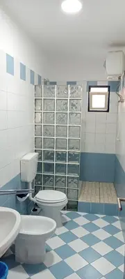 a blue and white bathroom with a toilet and sink at Canova Apartment in Santa Maria