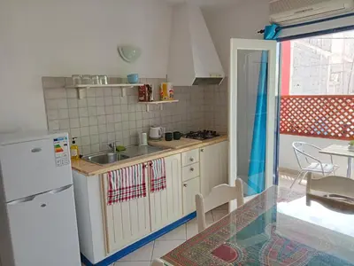 a kitchen with a white refrigerator and a sink at Canova Apartment in Santa Maria