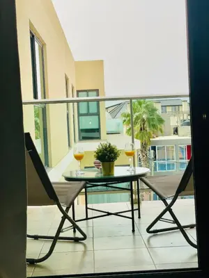 a table and two glasses of wine on a balcony at Sal Little Heart Blue Apartment 13 in Santa Maria