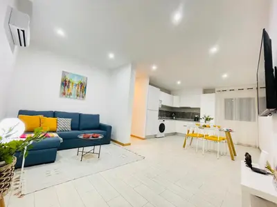 a living room with a blue couch and a kitchen at Sal Little Heart Blue Apartment 13 in Santa Maria