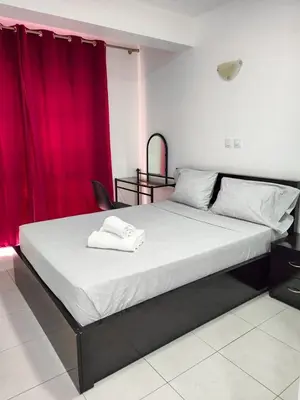 a bedroom with a large bed with a red curtain at LAR DO VIAJANTE, Ribeira Grande Santo Antão in Ribeira Grande