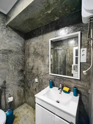 a bathroom with a sink and a mirror at LAR DO VIAJANTE, Ribeira Grande Santo Antão in Ribeira Grande