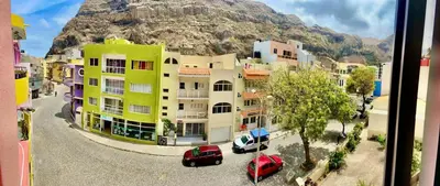 a view of a city with a mountain in the background at LAR DO VIAJANTE, Ribeira Grande Santo Antão in Ribeira Grande