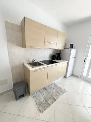 a kitchen with a sink and a refrigerator at Blue Oceano in Santa Maria