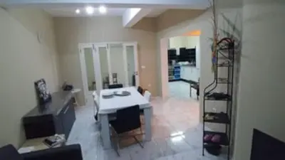 a living room with a white table and a staircase at Casa da Lalá - casa com 3 quartos e espaços exteriores! in Mindelo