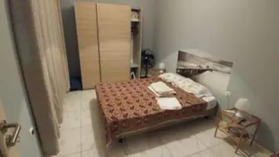 a bedroom with a bed in a room with a shower at Casa da Lalá - casa com 3 quartos e espaços exteriores! in Mindelo