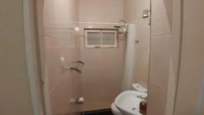 a bathroom with a toilet and a sink and a shower at Casa da Lalá - casa com 3 quartos e espaços exteriores! in Mindelo