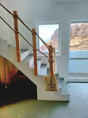 a room with a staircase with a bag hanging from it at Domus Belota in Ribeira Grande