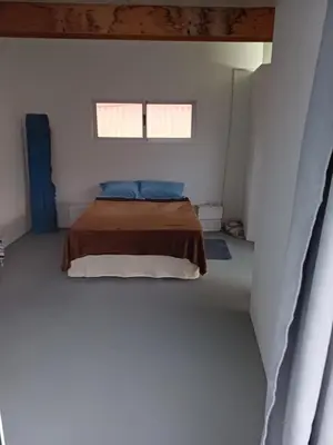 a bedroom with a bed in a white room at Domus Belota in Ribeira Grande