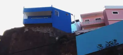 a blue building on the side of a hill at Domus Belota in Ribeira Grande