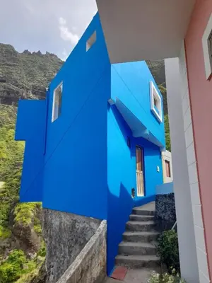 a blue house with stairs in front of it at Domus Belota in Ribeira Grande