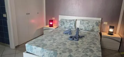 a bedroom with a large bed with two night stands at Ocean Breeze in Sal Rei