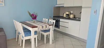 a small kitchen with a table with chairs and a tableablish at Ocean Breeze in Sal Rei