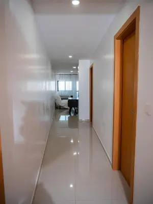 a hallway with white walls and a table in a room at Appartement moderne avec vue sur la mer in Praia
