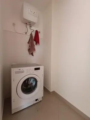 a washing machine in a laundry room with a dryer at Elly Apartamentos in Mindelo