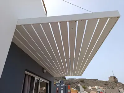 awning on a building with a mountain in the background at Elly Apartamentos in Mindelo