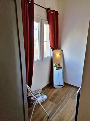 a room with a small refrigerator and a window at Holiferias NoStress Sal Island in Santa Maria
