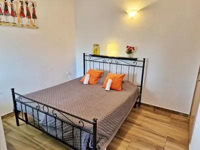 a bed in a room with orange pillows on it at Holiferias NoStress Sal Island in Santa Maria