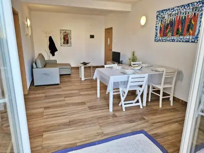 a dining room and living room with a table and chairs at Holiferias NoStress Sal Island in Santa Maria