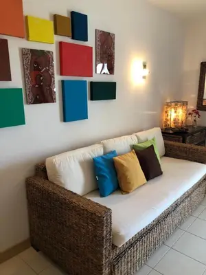 a couch in a room with colorful pillows on it at Patys in Santa Maria