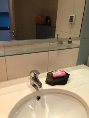 a bathroom counter with a sink and a mirror at Patys in Santa Maria