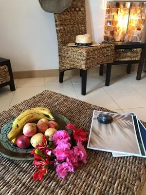 a bowl of fruit and flowers on a table at Patys in Santa Maria
