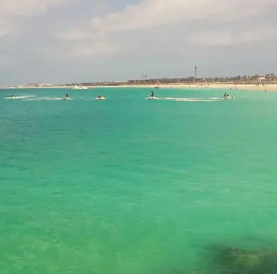 a group of people in the water at the beach at Patys in Santa Maria
