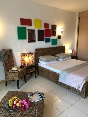 a bedroom with a bed and a table with a bowl of fruit at Patys in Santa Maria