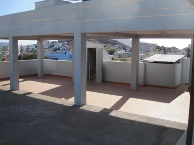 a building with a white roof with a view of a city at Maya Mindelo 4 in Mindelo