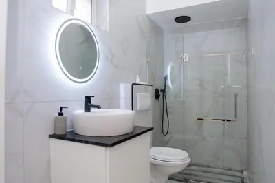 a white bathroom with a sink and a shower at Your Escape Home in Praia in Praia