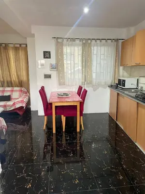 a kitchen and dining room with a table and chairs at MeM Apartment in Praia